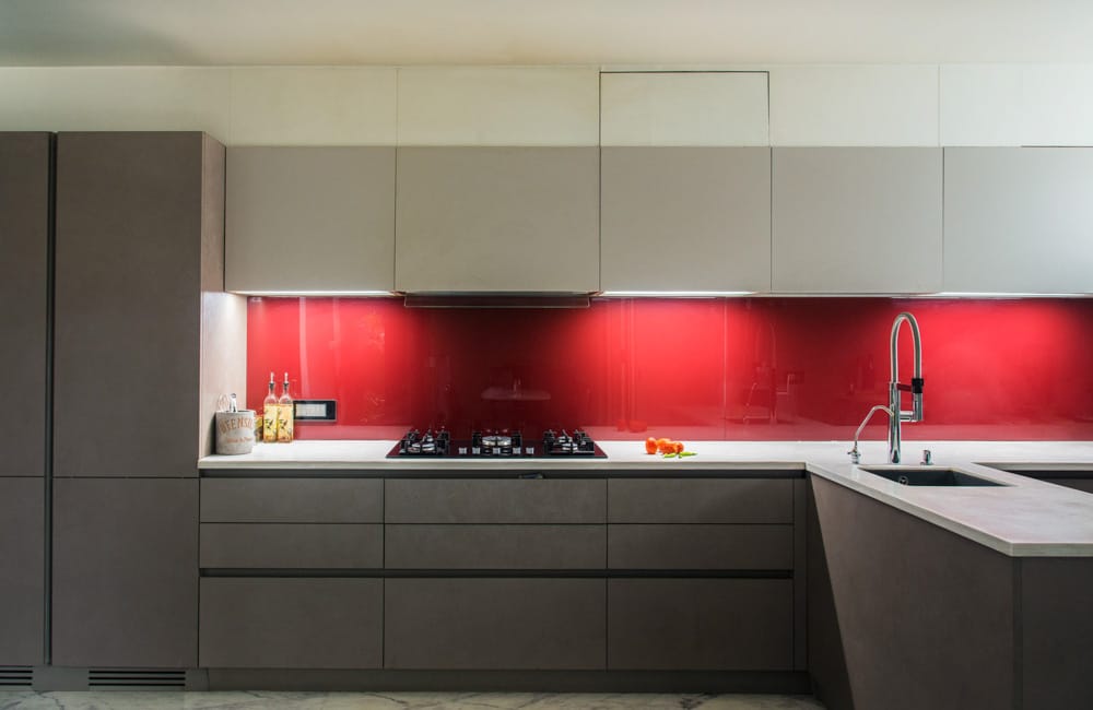 Modern Kitchen Design with Bright Red Backsplash in Glossy Finish in a Muted Kitchen - Beautiful Homes